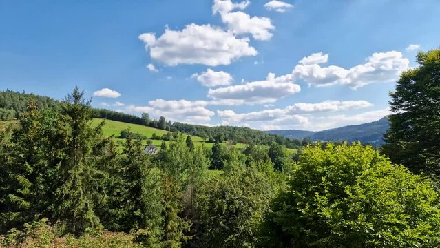View on the Vistula valley and the peaks of Silesian Beskid on a sunny summer day.  tourist town Wisla, Poland. timelapse