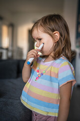 caucasian girl toddler with painted color draws and stains on face