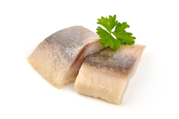 Marinated atlantic herring, sliced fish fillet with parsley leaf, isolated on white background.