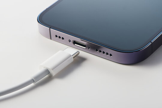 Apple iPhone with usb type-c cable. New USB Type-C interface of IPhone for charge and high speed data communication. New cable standard for Apple's devices. Apple's gadgets.