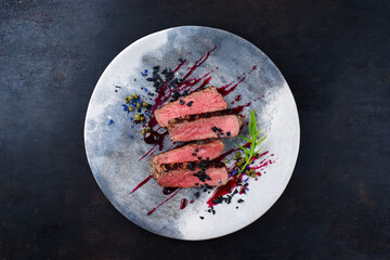 Gourmet barbecue dry aged angus roast beef steak with capers and rocket lettuce in amarena cherry...