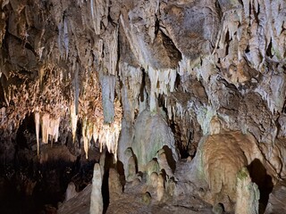 grotta con stalattiti e stalagmiti, attraversata dal fiume