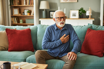 Fototapeta premium A senior man suffering from chest pain or heart attack at home