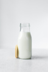 rosemary sugar cookies  and a bottle of milk on a marble tray,  cookies and milk on a white background, no spread round sugar cookies with a milk bottle