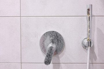 Dirty calcified shower mixer tap, faucet with limescale on it, plaque from hard water, Chrome...