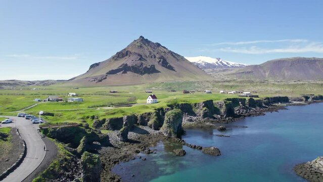 Arnastapi fishing village with white house and mount Stapafell on coastline in Snaefellsnes peninsula