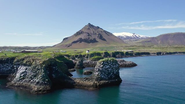 Arnastapi fishing village with white house and mount Stapafell on coastline in Snaefellsnes peninsula