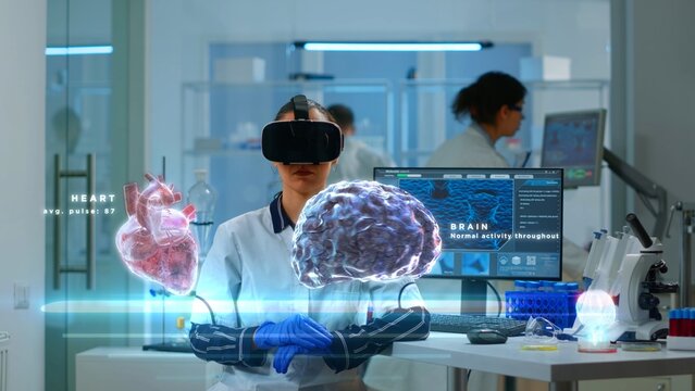 Scientific expert in modern lab wearing VR headset, using advanced equipment and wired sensors to contribute to neurology research. Specialist using virtual reality technology to gain medical insights