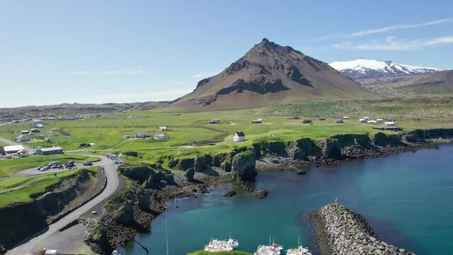 Arnastapi fishing village with white house and mount Stapafell on coastline in Snaefellsnes peninsula