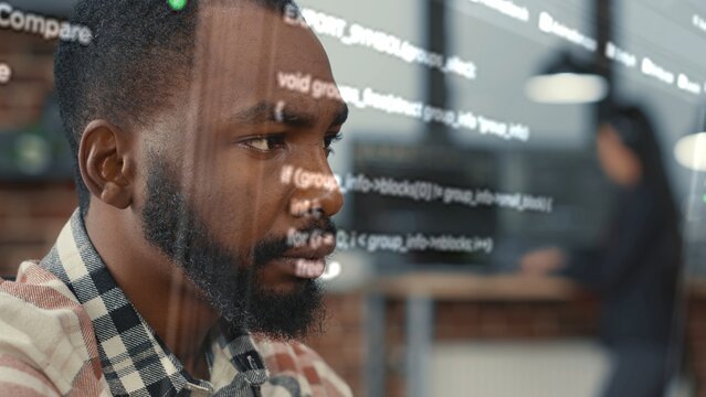 Developer helped by augmented reality to visualize script, writing code on computer screen while in workspace using Java programming languages. African american licensed professional mending errors