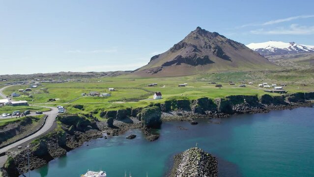 Arnastapi fishing village with white house and mount Stapafell on coastline in Snaefellsnes peninsula