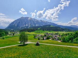 Summer austrian landscape with Grimming mountain (2.351 m), an isolated peak in the Dachstein Mountains, view from small alpine village Tauplitz, Styria, Austria - obrazy, fototapety, plakaty