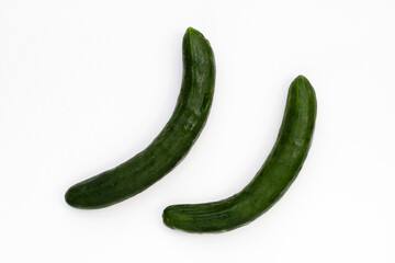 Fresh long cucumbers on a white background