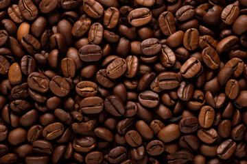 Close close-up of roasted coffee beans with copy space.