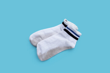Dirty white socks on blue background.