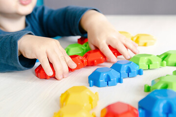 Little child boy playing mosaic constructor.Babys hands building figures of blocks.Children logic,fine motor skills development,kindergarten.Early sensory education.Activities Montessori