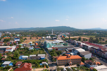 Naklejka na ściany i meble Aerial view of residential neighborhood roofs. Urban housing development from above. Top view. Real estate in Mukdahan, Isan province city, Thailand. Property real estate.