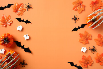 Happy Halloween holiday frame. Scary bats, pumpkins, ghosts, fallen leaves on orange table. Flat lay, top view, copy space.