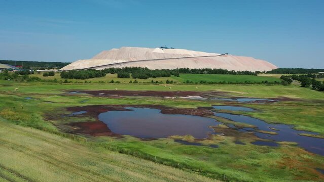 Salty pond, behind it overburden dump of the K&S potash plant, Zielitz, Saxony-Anhalt, Germany, Europe