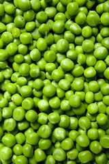Background of fresh organic sweet green peas, pea grains close-up, top view.