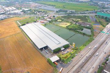 Aerial top view of concrete industry factory in urban city town. Business distribution logistic transport in Thailand.