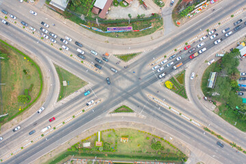 Aerial view of cars driving on highway junction or moterway. Overpass bridge street roads in connection network of architecture concept. Top view. Urban city, Bangkok, Thailand.