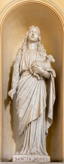 NAPLES, ITALY - APRIL 22, 2023: The marble statue of St. Agnes in the church Basilica dell Incoronata Madre del Buon Consiglio from 20. cent.

