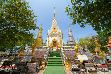 Naklejka premium Wat Phrathat Phanom, Nakhon Phanom, Isan Temple. The pagoda is a buddhist temple in urban city town, Thailand. Thai architecture landscape background. Tourist attraction landmark.