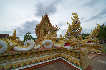 Fototapeta premium Wat Nong Hu Ling, Maha Sarakham, Isan Temple. The pagoda is a buddhist temple in urban city town, Thailand. Thai architecture landscape background. Tourist attraction landmark.