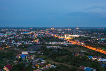 Aerial view of residential neighborhood roofs. Urban housing development from above. Top view. Real estate in Kalasin, Isan province city, Thailand. Property real estate at night.
