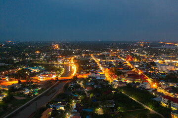 Aerial view of residential neighborhood roofs. Urban housing development from above. Top view. Real estate in Kalasin, Isan province city, Thailand. Property real estate at night.