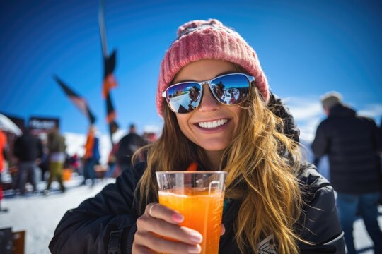 A young woman enjoying a drink at ski resort