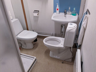 Obraz na płótnie Canvas two toilets inside a restroom