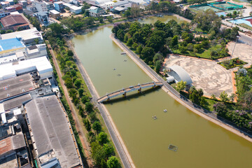 Aerial top view of a garden park with green forest trees, river, pond or lake. Nature landscape background, Thailand.