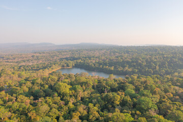 Aerial top view of a garden park with green forest trees, river, pond or lake. Nature landscape background, Thailand.