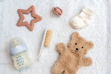 Newborn accessories displayed in flat lay, top view of essential infant items for care and comfort