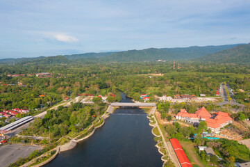 Fototapeta na wymiar Aerial top view of a garden park with green forest trees, river, pond or lake. Nature landscape background, Thailand.