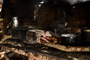 wood stove, wood-burning stove, firewood in the kitchen, stove flame, simple house in the interior of Brazil, mud house, northeastern reality, social inequality, poverty in Brazil, burnt pans