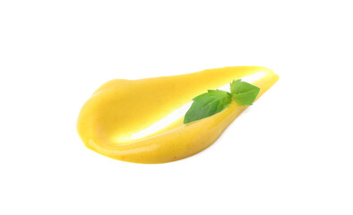 Smear of tasty curry sauce and basil leaf isolated on white