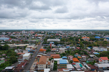 Obraz premium Aerial view of local residential neighborhood roofs. Urban housing development from above. Top view. Real estate in Isan urban city town, Thailand. Property real estate.