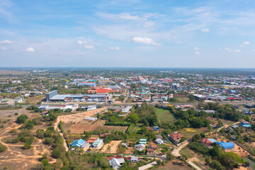 Fototapeta premium Aerial view of local residential neighborhood roofs. Urban housing development from above. Top view. Real estate in Isan urban city town, Thailand. Property real estate.
