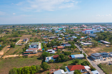 Obraz premium Aerial view of local residential neighborhood roofs. Urban housing development from above. Top view. Real estate in Isan urban city town, Thailand. Property real estate.