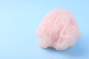 One sweet cotton candy on light blue background. Space for text