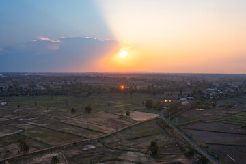 Obraz premium Aerial top view of fresh paddy rice, green agricultural fields in countryside or rural area in Asia, Thailand. Nature landscape