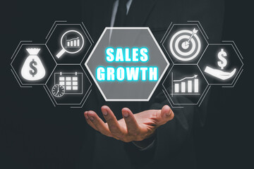 Naklejka premium Sales growth concept, Business person hand holding sales growth icon on virtual screen.