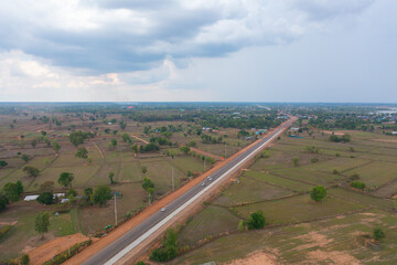 Aerial top view of fresh paddy rice, green agricultural fields in countryside or rural area in Asia, Thailand. Nature landscape