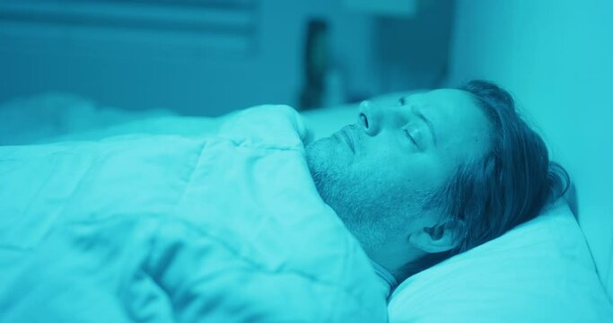 Man sleeping blue lights alien abduction ghost bedroom
