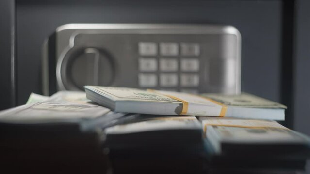 A safe with earnings money. Strongbox with pile of dollars cash. Banking deposit box. Storage of euros and dollars savings. Concept of finance investment safety or business security