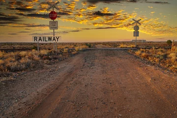 Fototapete Honigfarbe Railway crossing in SA in the sunset