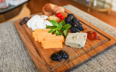 Charcuterie and dessert dinner. Symbolizing communal sharing, diverse flavors, unity through culinary delights